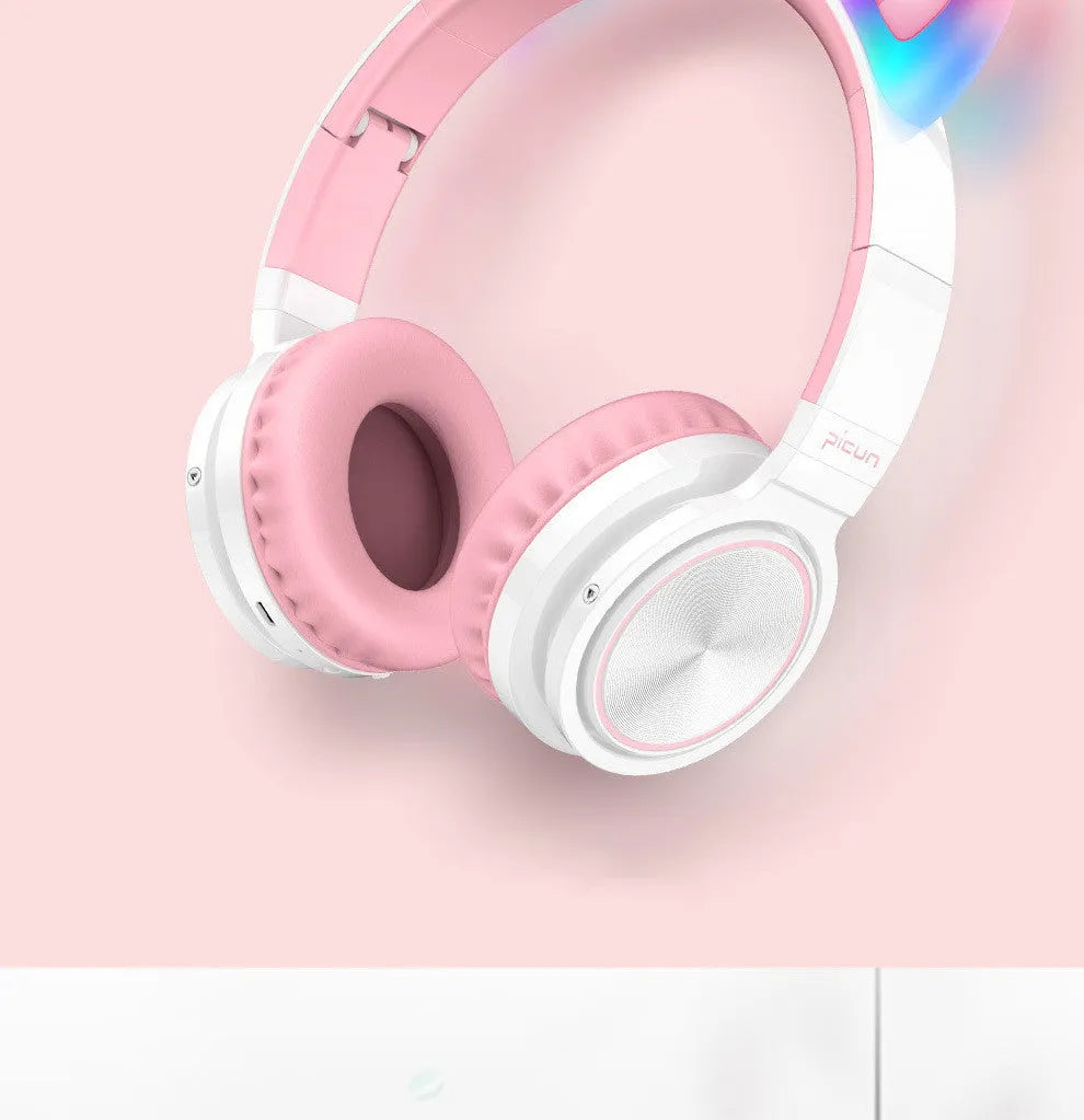 Pink and white Bluetooth over-ear headphones with braided cable and built-in microphone