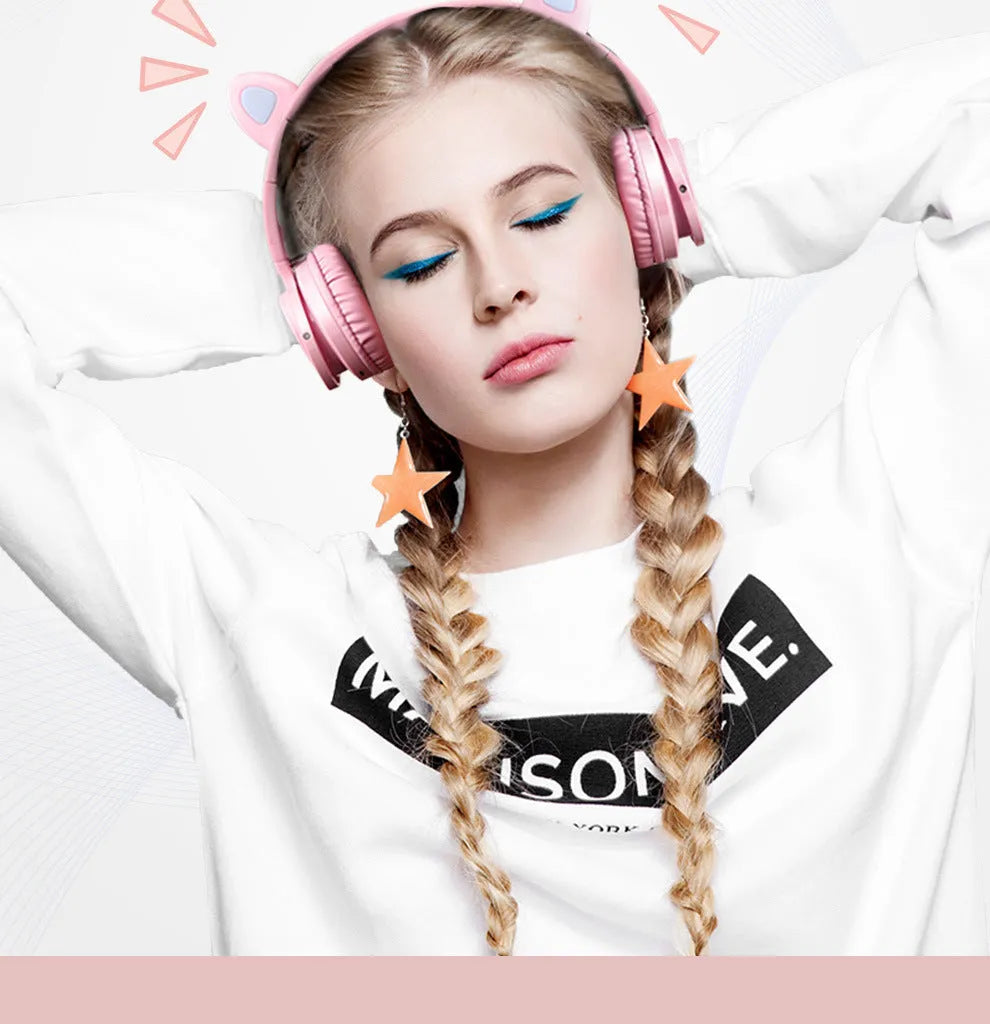 Pink and white Bluetooth over-ear headphones with braided cable and built-in microphone
