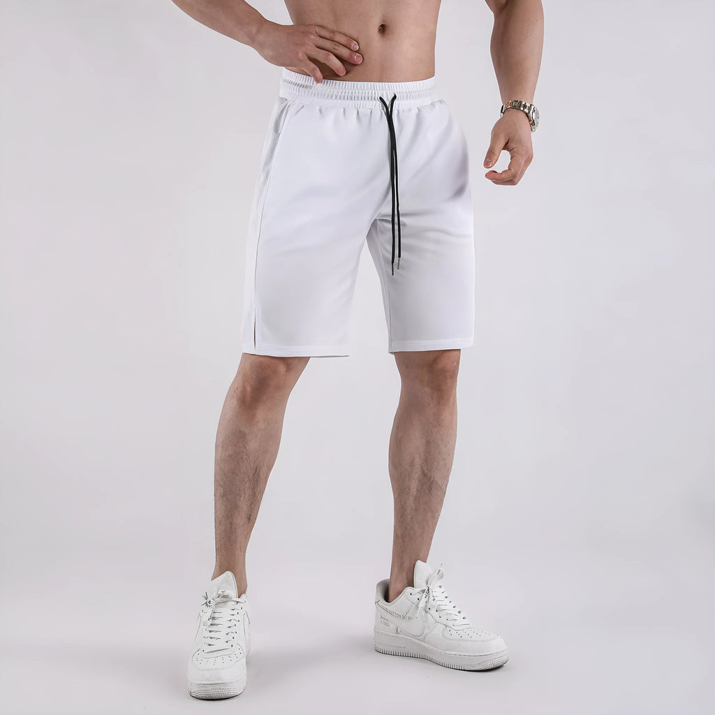 Man wearing loose-fitting black quick-dry mesh shorts with an elasticated waist.
