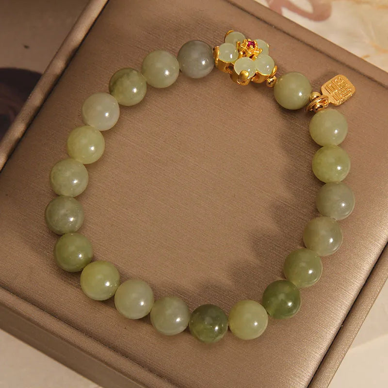 A grey jade and alloy casual bracelet for women, showing its unique design.