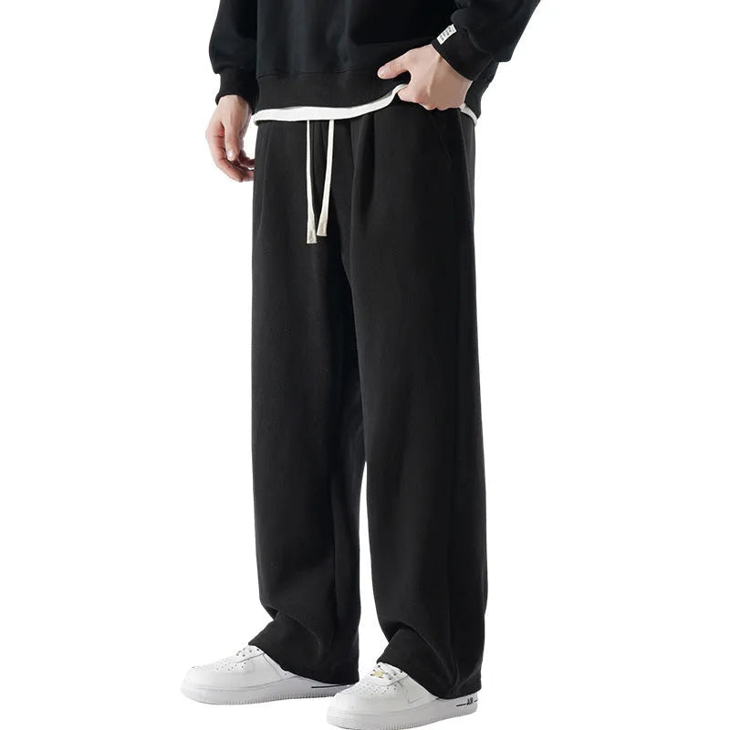Men's double-sided polar fleece winter sports trousers in apricot colour, showing loose fit and drawstring waistband.