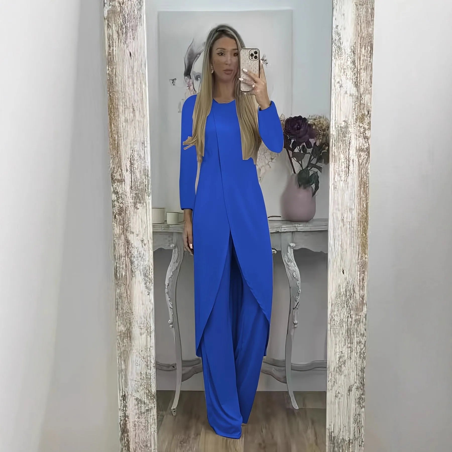 Women's black polyester two-piece lounge set with long sleeve top and loose trousers on a hanger.