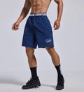 Men's loose fit black sports shorts with an elastic waistband, shown from the front.