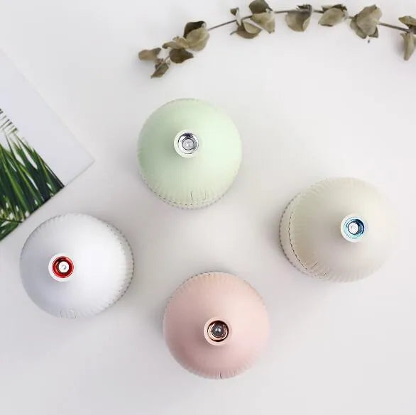 White ultrasonic aromatherapy diffuser with 300ml capacity, USB port, and LED light on wooden surface