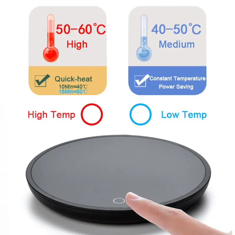 Black coffee mug warmer with temperature switch on desk next to ceramic cup