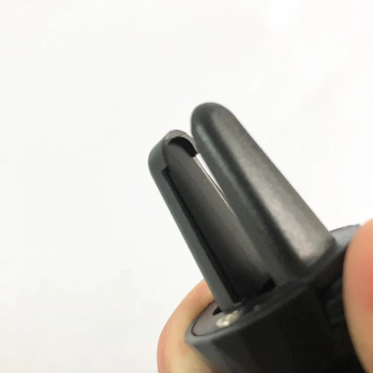 Glossy black car phone holder mounted on car air vent for smartphone securement