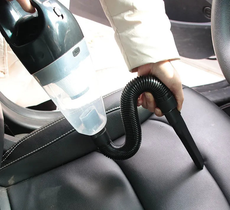 Orange portable handheld car vacuum cleaner with nozzles and a long power cord for 12V socket use.