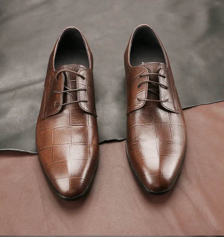 Men's black and brown checkered patterned cow leather derby shoes with pointed toe on a rubber sole.
