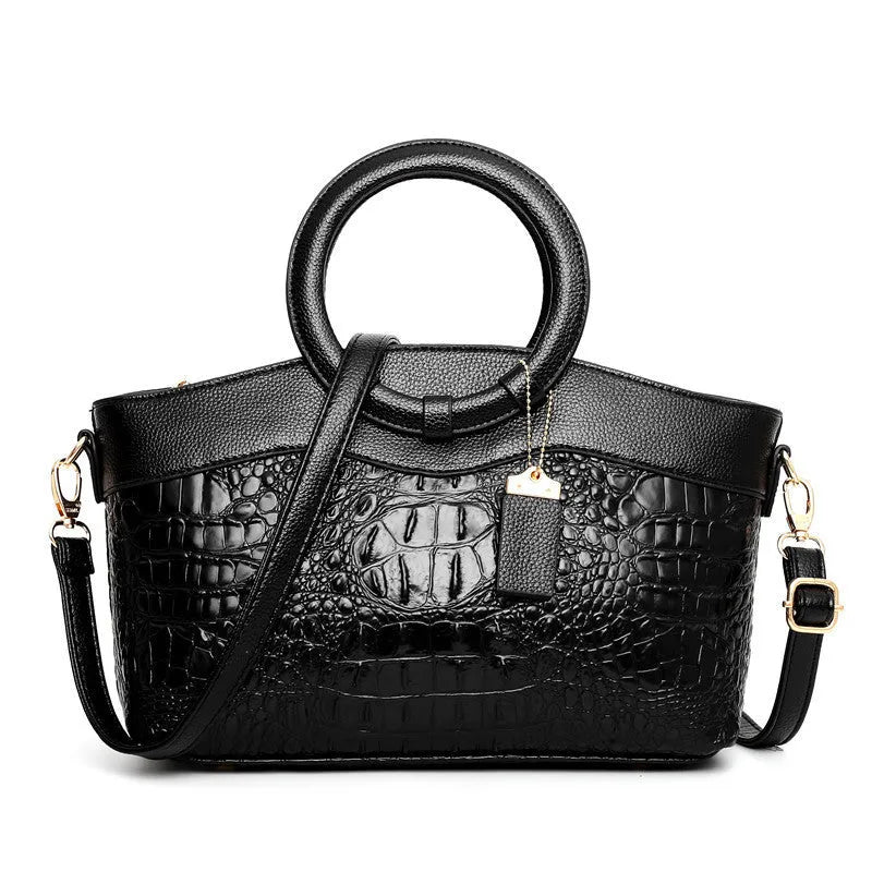 Fabric women's handbag showing multiple zipper compartments and organisational pockets