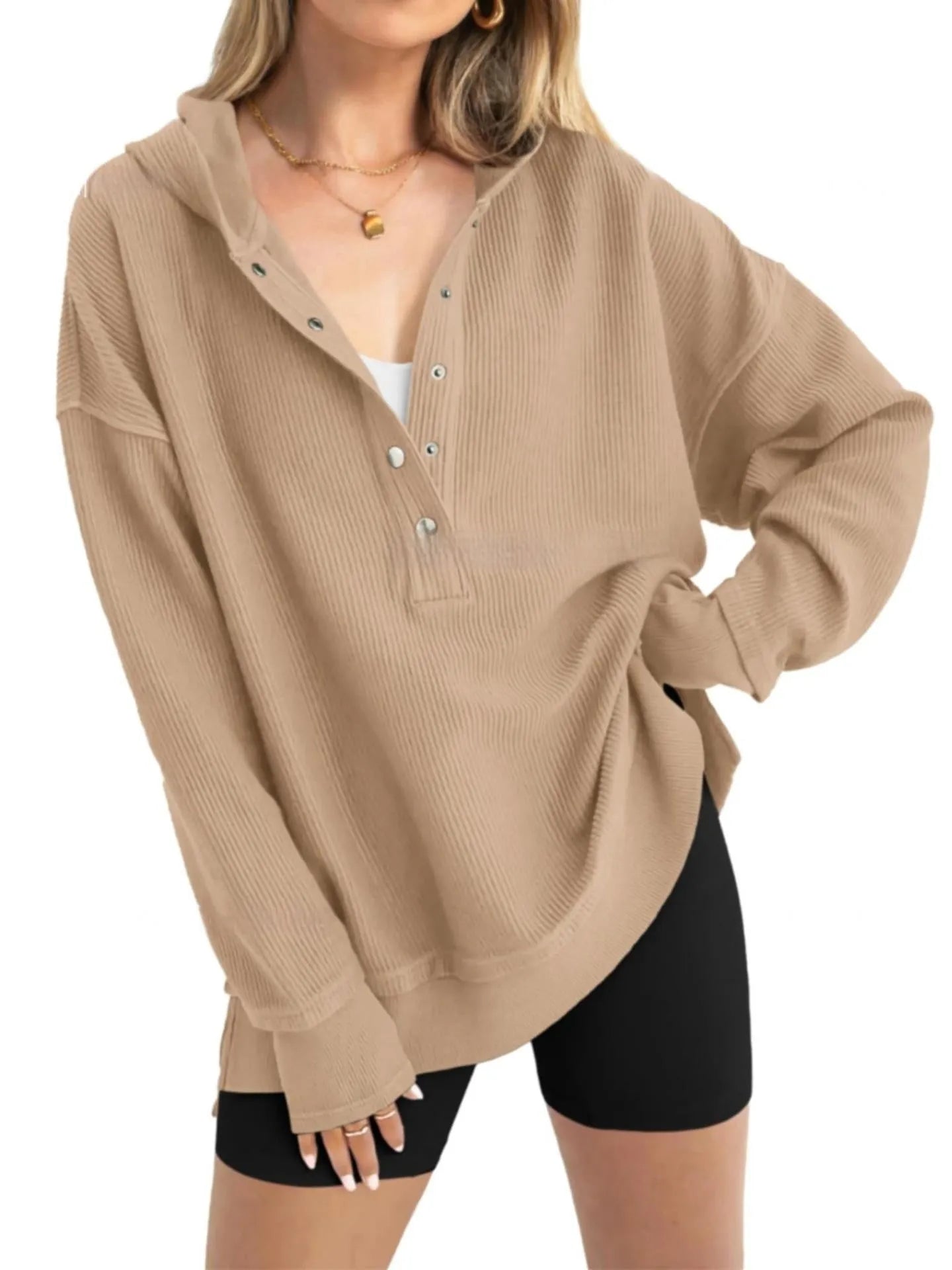 Women's loose-fitting solid colour pullover sweater with long raglan sleeves on a hanger.