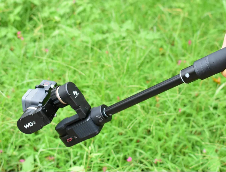Black retractable selfie stick with hand-held stabiliser extended for smartphone photography