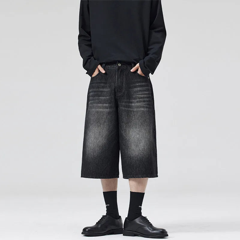 Men's light blue denim shorts with a straight-leg, cropped cut on a casual background.