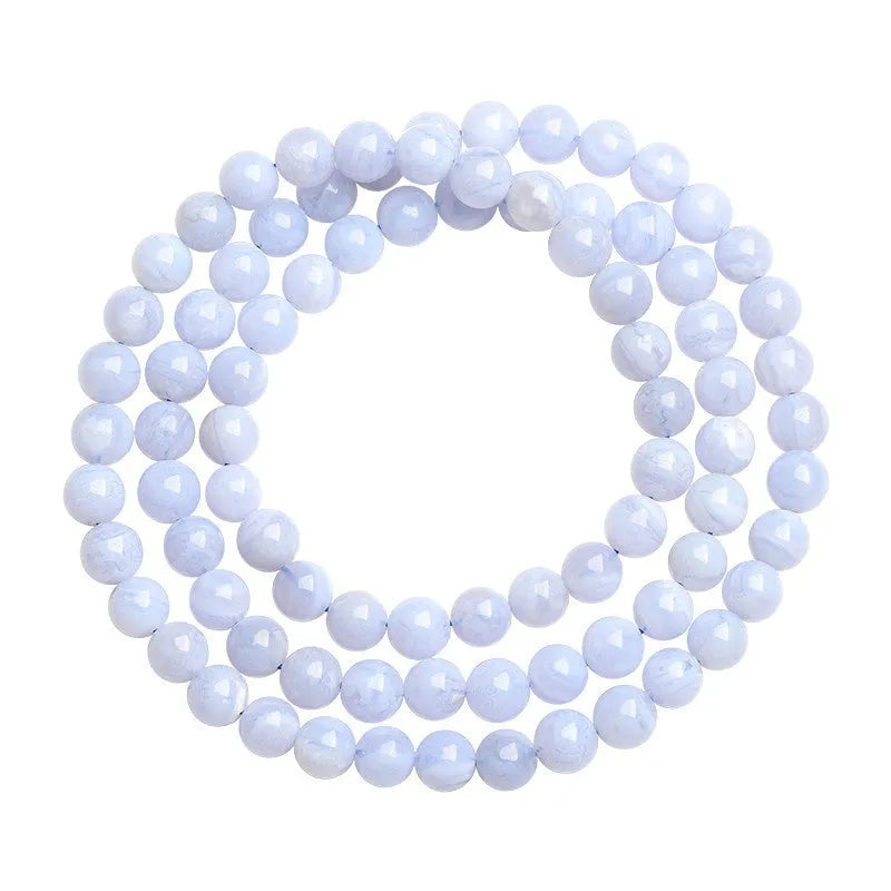Blue agate bracelet with patterned ball and striped scattered beads showing three-circle construction