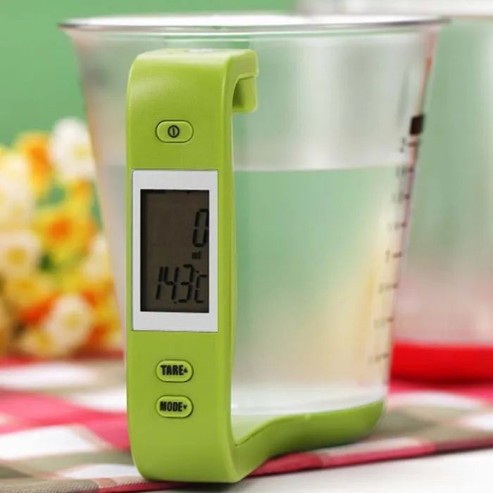 Green digital kitchen measuring cup scale with LCD display in handle