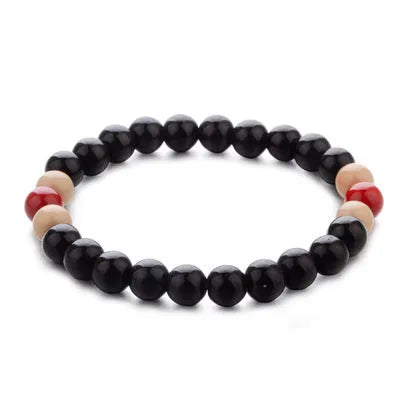 Natural stone beaded bracelet with lava stone charms on wrist, showing ethnic design and 18cm unisex fit.