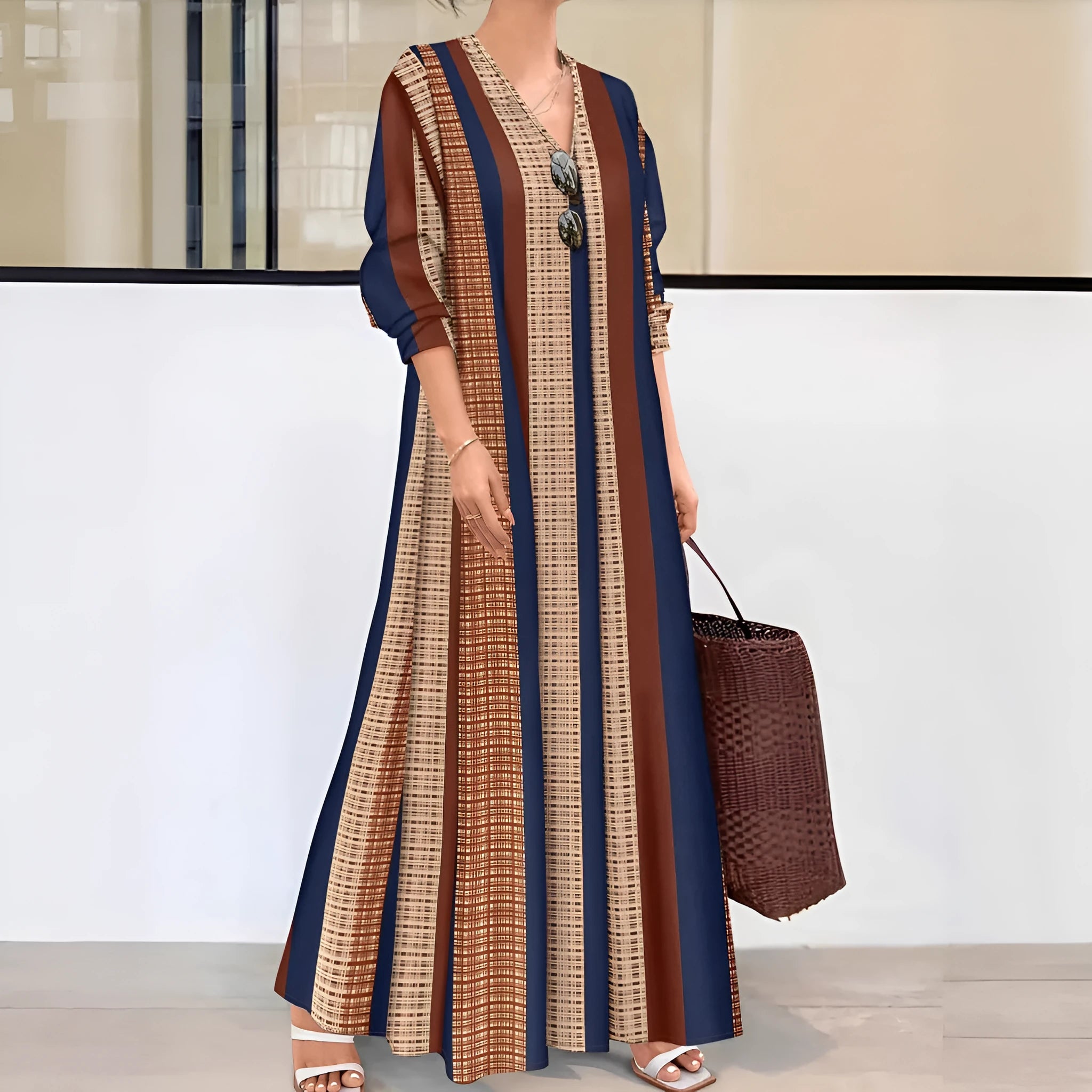 Camel-colour women's knitted V-neck dress with vertical stripes and long A-line skirt.