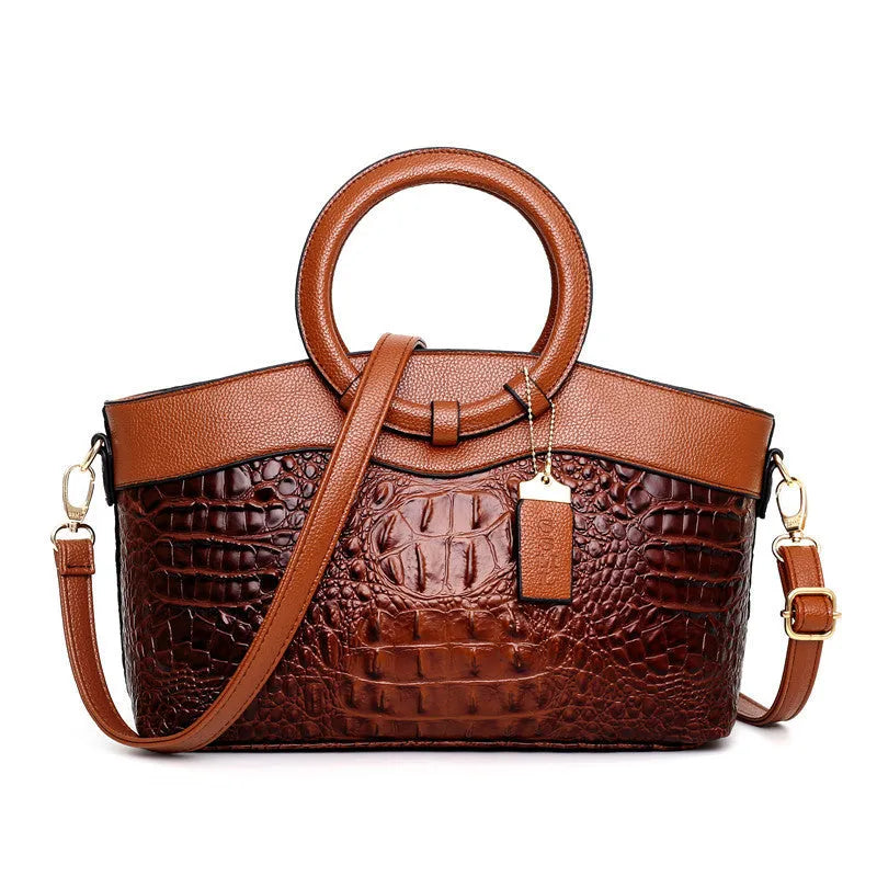 Fabric women's handbag showing multiple zipper compartments and organisational pockets