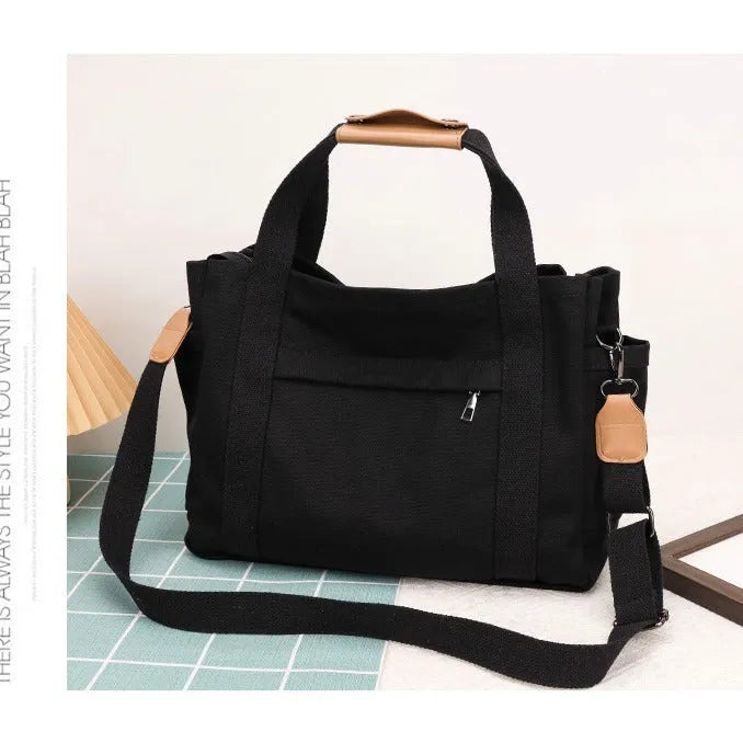 Women's large capacity canvas crossbody tote bag with organiser pockets in black colour