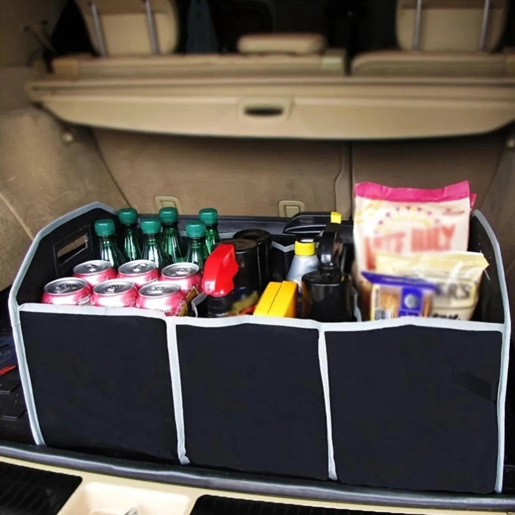 Black car multi-pocket trunk organiser with foldable lid and tie-down straps on car boot floor
