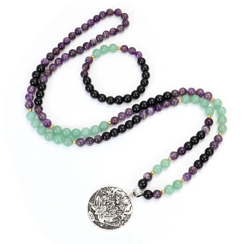 Handmade yoga necklace with lotus pendant and stone beads alongside matching bracelet