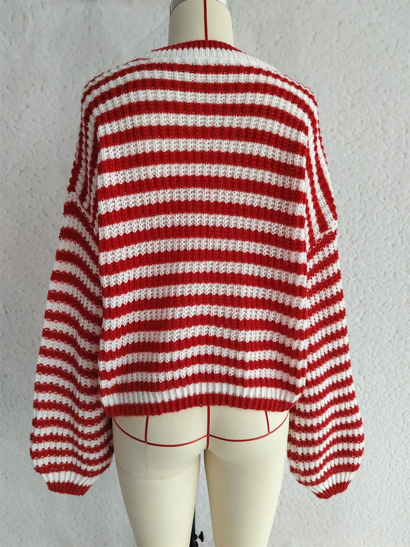 Women's black and white striped loose-fit pullover sweater with long sleeves and a round neck.