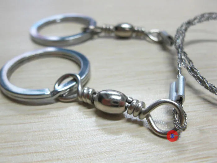Outdoor survival wire saw with stainless steel blade, pull rings, and hoop showing 55cm cutting length