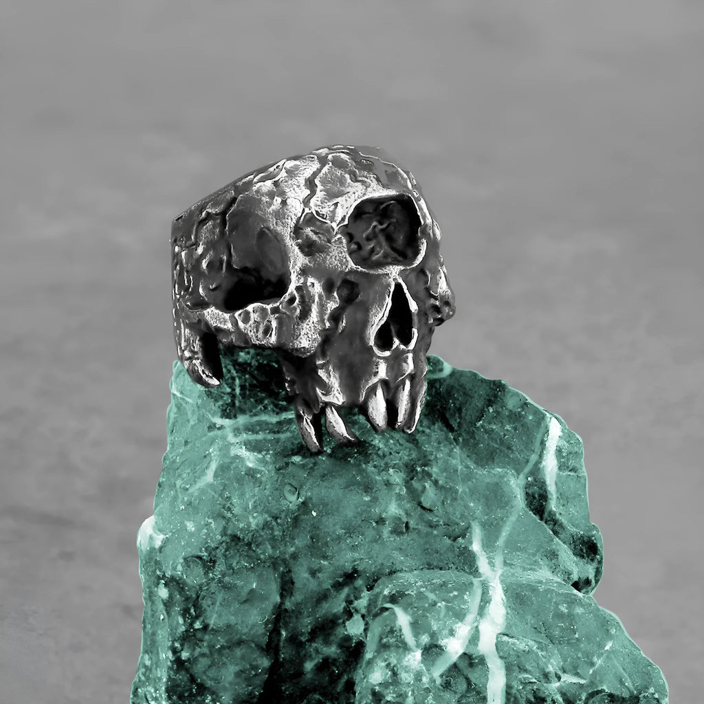 Alloy skull ring with one-eyed design and electroplated metallic finish shown on hand
