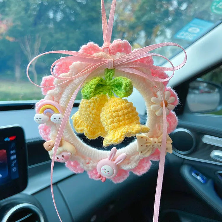 Woven wool bell orchid car pendant hanging display showing colour options including green, pink, purple and yellow variations