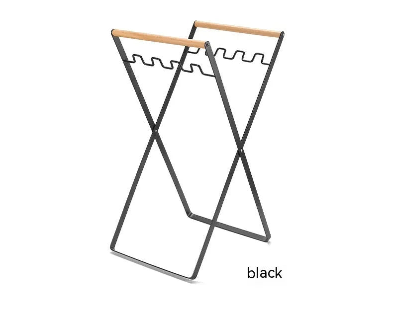 Black folding iron trash storage rack with wooden handle holding rubbish bag