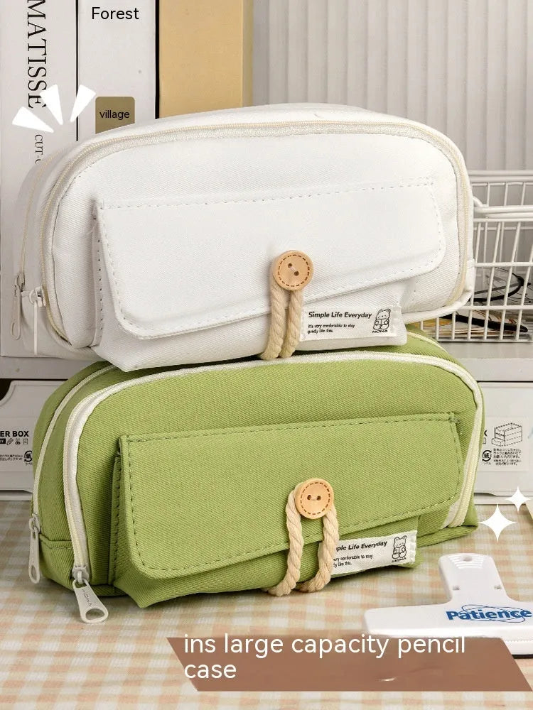 Korean-style canvas pencil case in green, beige, blue, and grey colours storing approximately 80 pens
