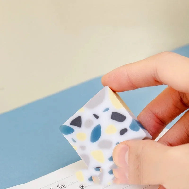White rubber brick-format eraser for students on a plain background