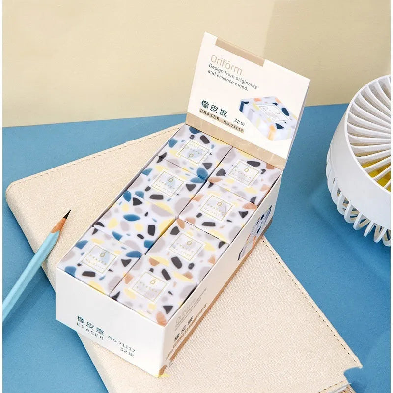 White rubber brick-format eraser for students on a plain background