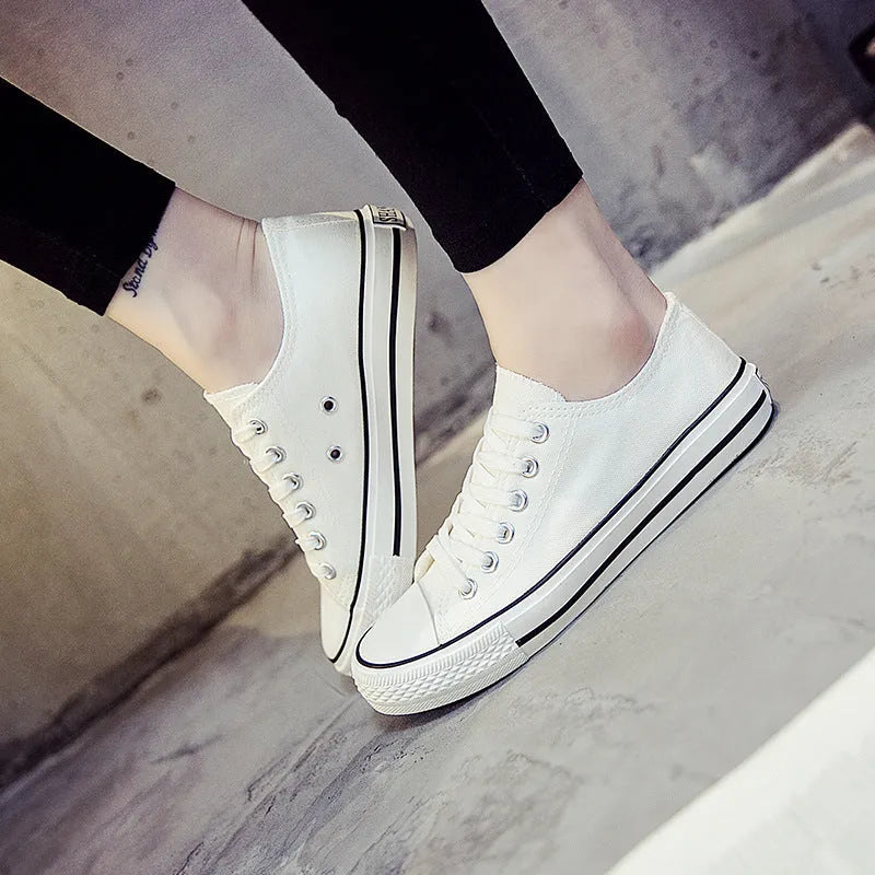 Women's solid colour canvas casual flat shoes on a plain background.