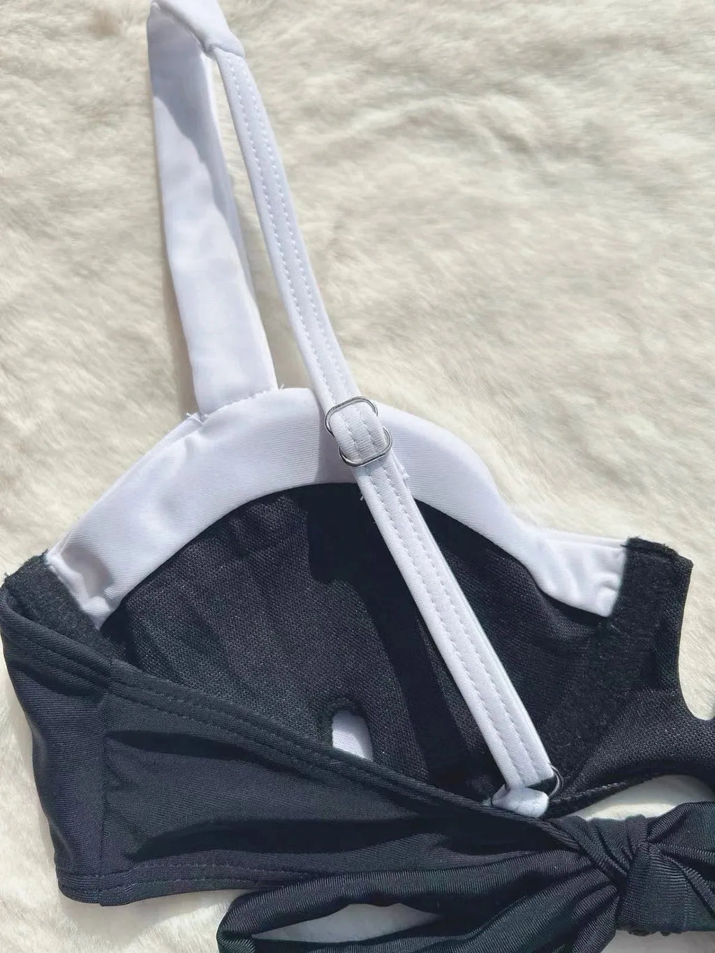 Black women's low waist bikini with stitching split detail on briefs, shown from front.
