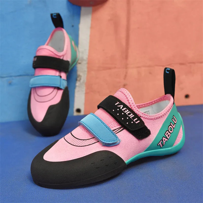 Beginner rock climbing shoes with Velcro strap and wear-resistant rubber sole in black and red colour.