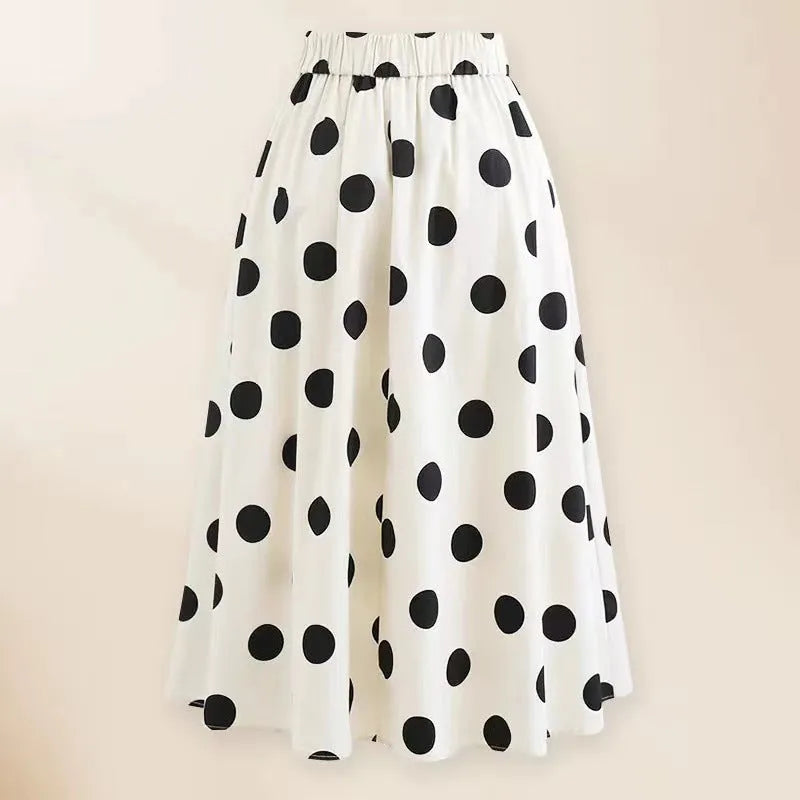 Women's black one-piece swimsuit with attached beach dress skirt featuring bow detail