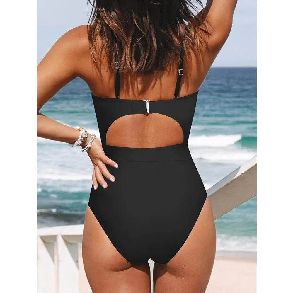 Solid colour women's one-piece swimsuit with cross-back design on mannequin.