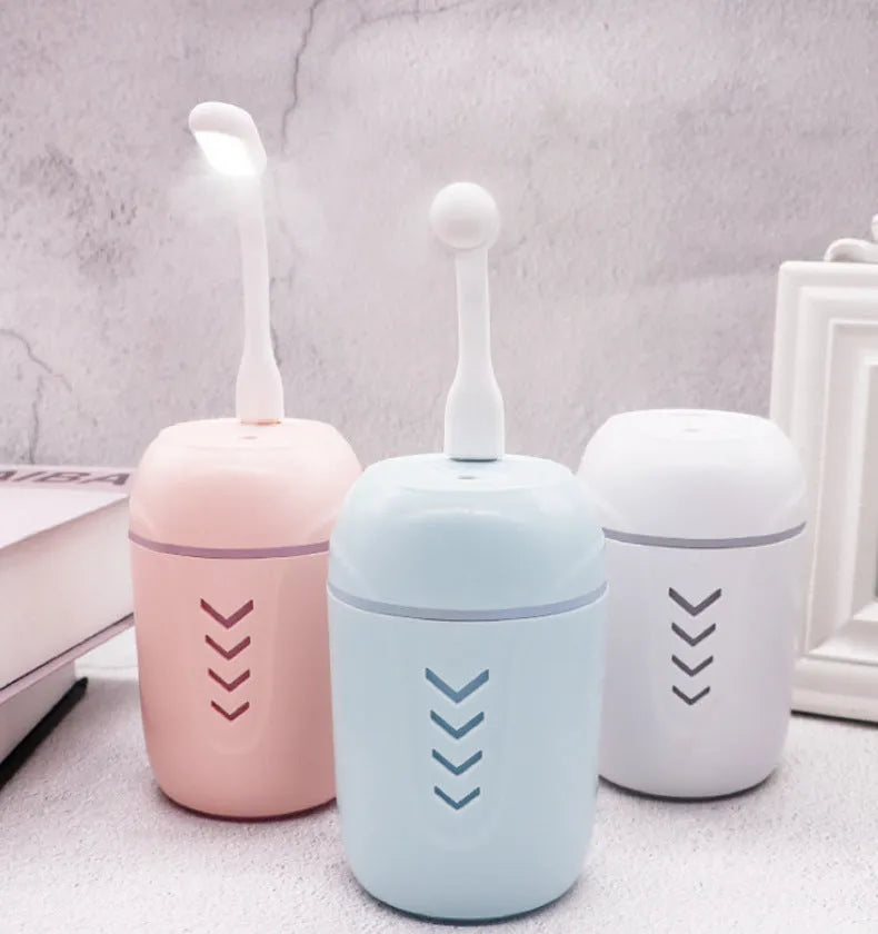 Portable columnar humidifier with 200ml capacity in blue, pink, or white colours showing USB and AC power options