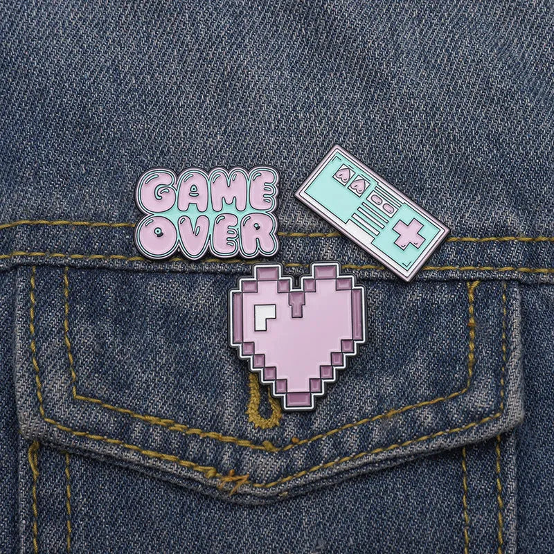 Stereo game console badge made from alloy, shown in one of three colour options with independent OPP packaging.