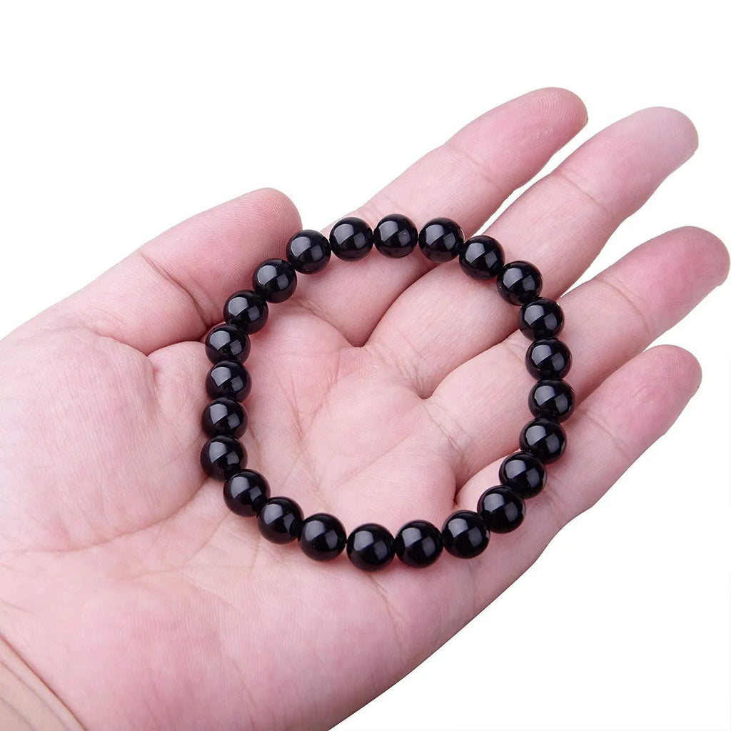 A geometric black agate bead stretch bracelet with 8mm stones on an elastic cord.