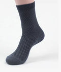 Men's bamboo fibre business socks in small square pattern, shown in classic colours on a grey background.