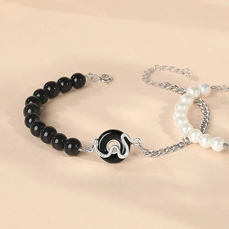 A pair of 925 sterling silver bracelets for men and women featuring a snake zodiac charm and a safety buckle clasp.