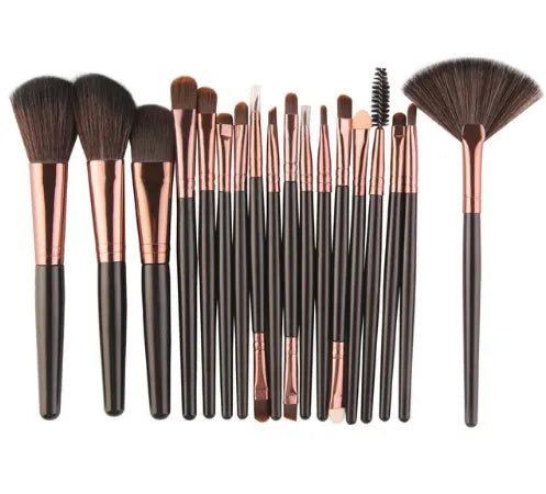 MAANGE 18 piece makeup brush set with fan-shaped brushes laid out on a table.