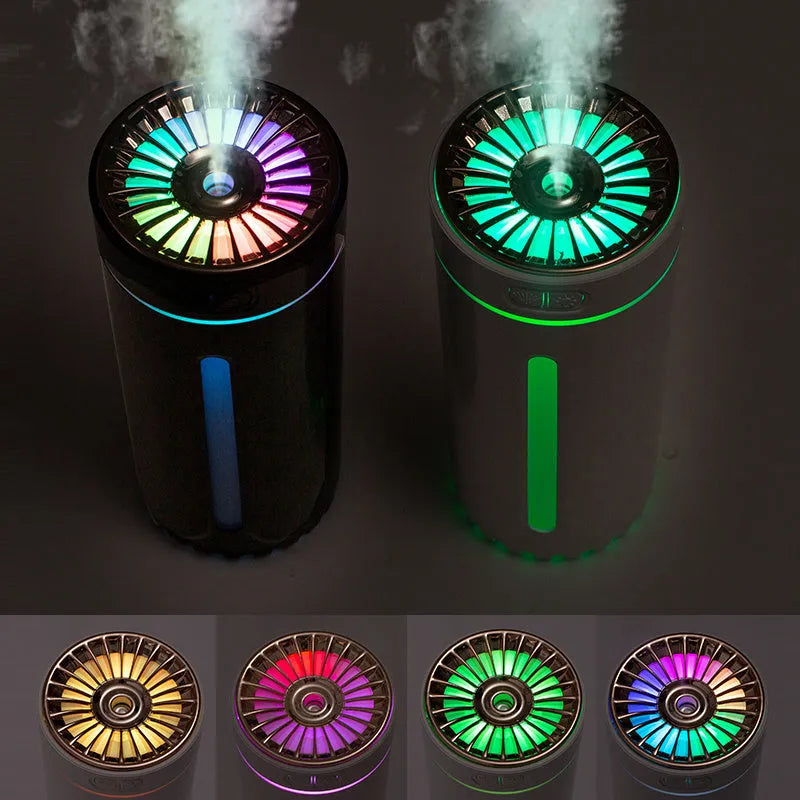 Black portable wireless ultrasonic humidifier with colourful LED lights on a car cup holder.