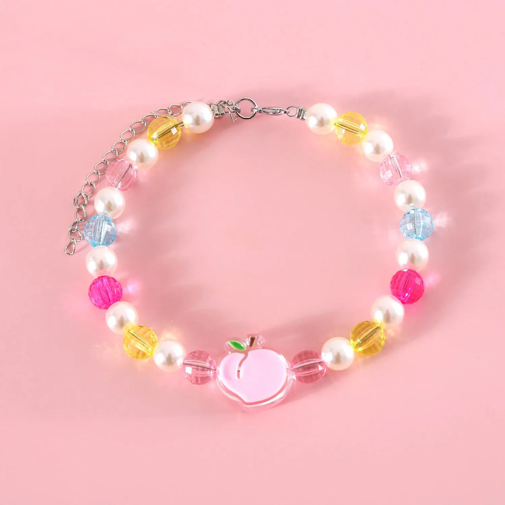 Colourful plastic pearl bead cat collar with a small flower charm on a white background.