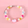 Colourful plastic pearl bead cat collar with a small flower charm on a white background.