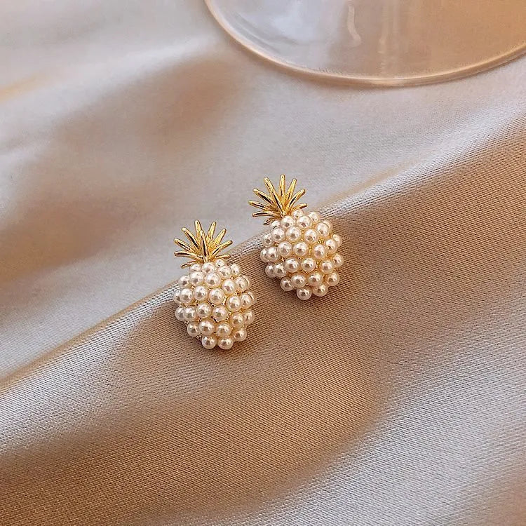 Women's gold electroplated alloy drop earrings with pineapple design and starfish pearl, featuring inlaid stones.