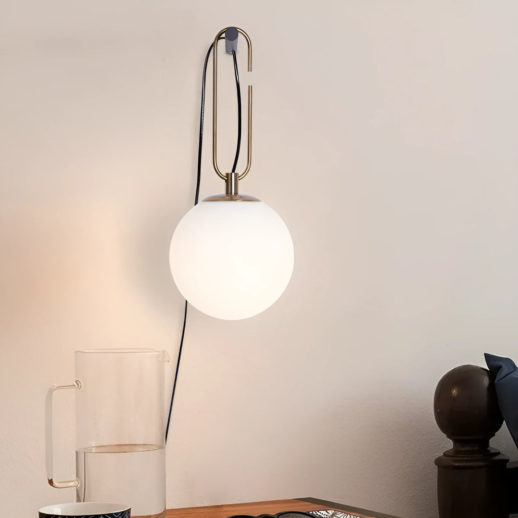 Nordic modern glass wall lamp on a white wall, showing its simple design and diffused light.