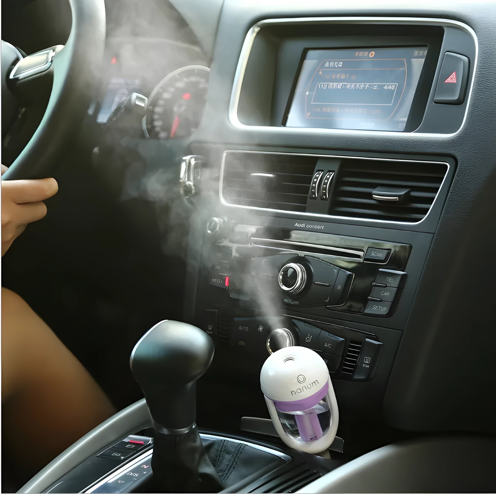 Compact blue car humidifier with rotating nozzle on a car dashboard