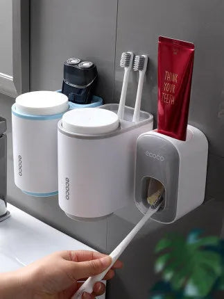 Wall mounted automatic toothpaste holder dispenser set with toothbrush slots and upside-down mouthwash cup in black plastic
